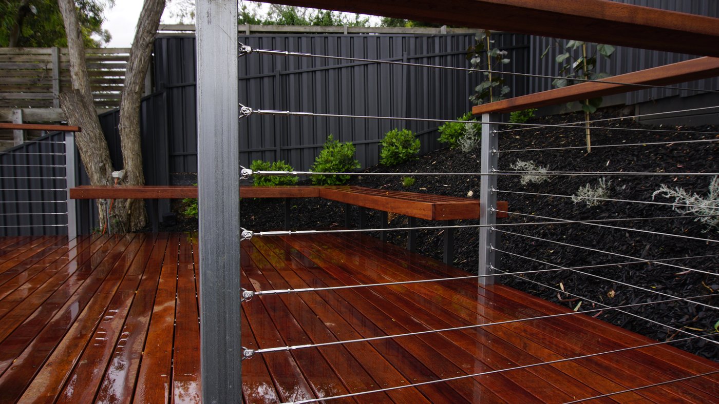 Finished timber deck in Glen Osmond with cable wire balustrade and built-in Merbau bench seating