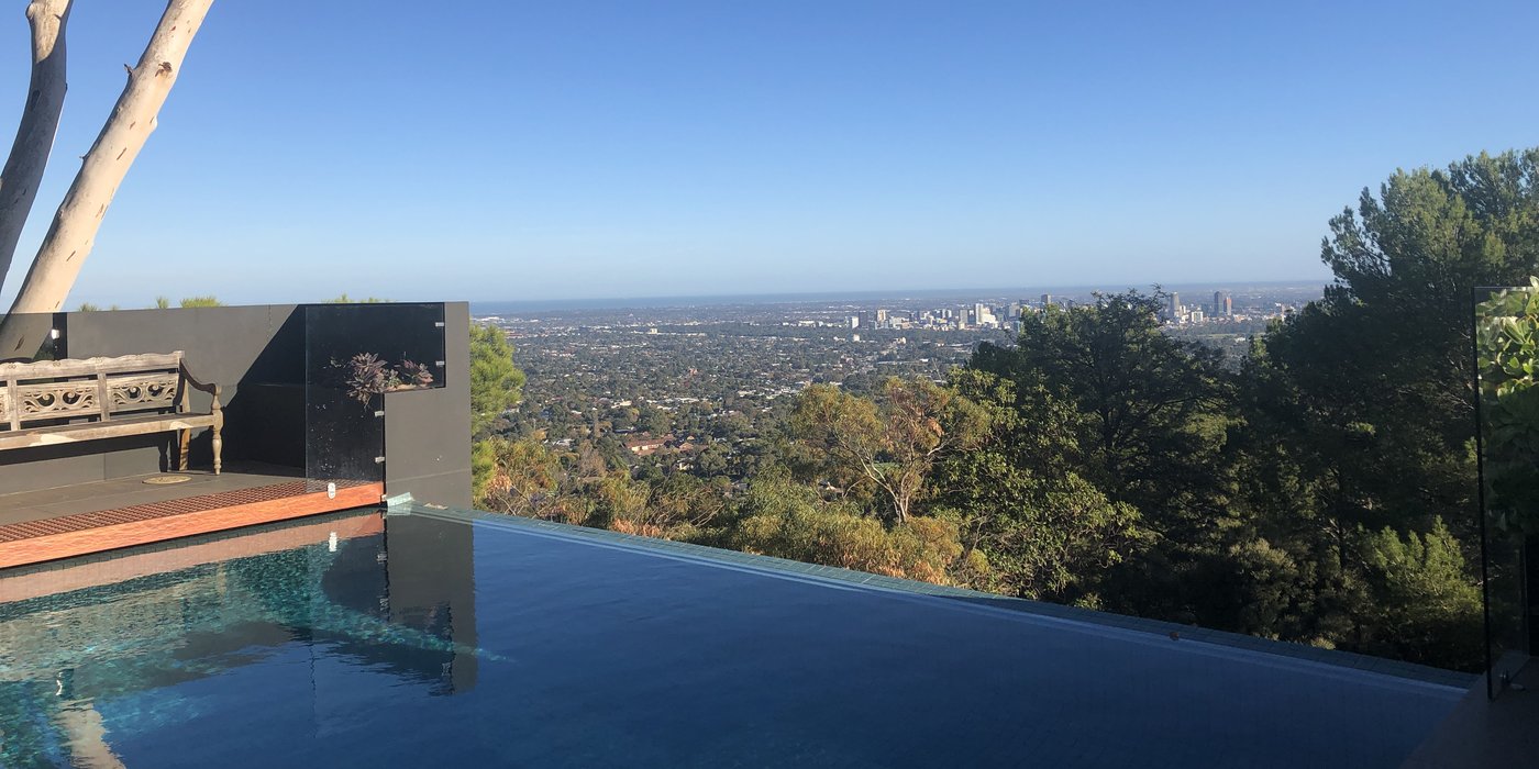 Finished infinity edge swimming pool overlooking the Adelaide city skyline in Glen Osmond