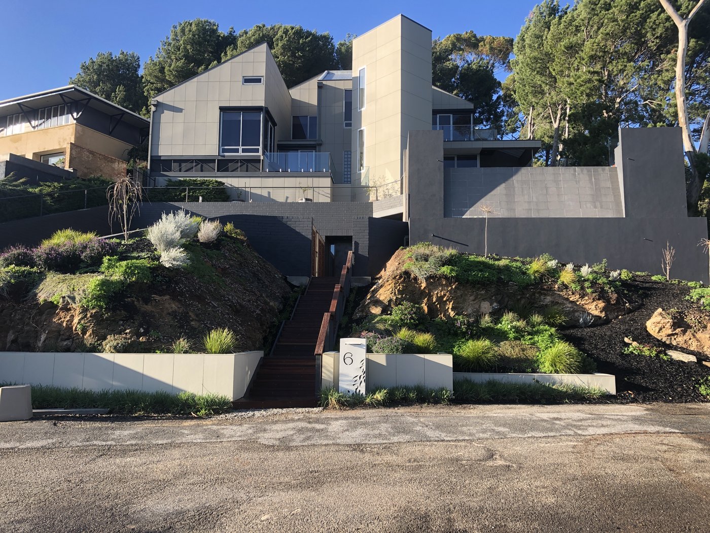 Finished front entrance timber stairway with landscaped retaining walls and planting in Glen Osmond