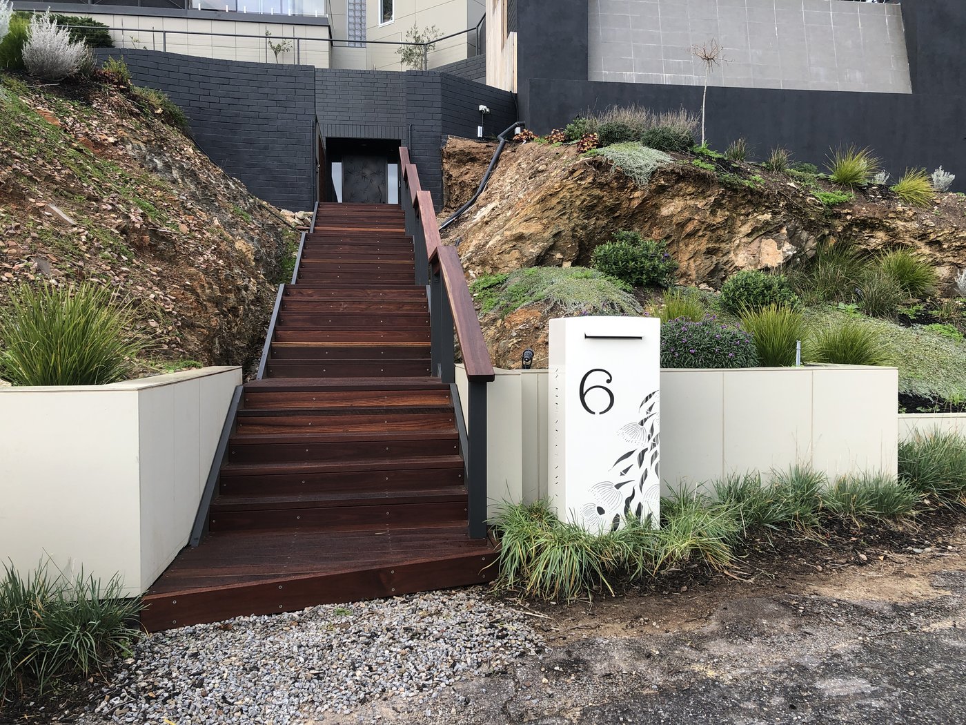 Finished hardwood timber stairway with steel balustrade and rendered retaining walls in Glen Osmond
