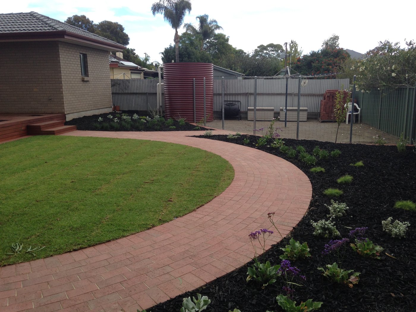 Finished brick paved path and garden bed alongside a new lawn in Oaklands Park