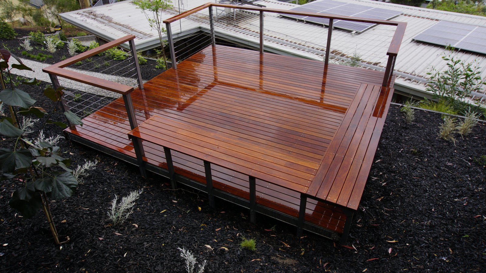 Elevated hardwood deck with cable balustrade overlooking a Glen Osmond backyard, freshly oiled