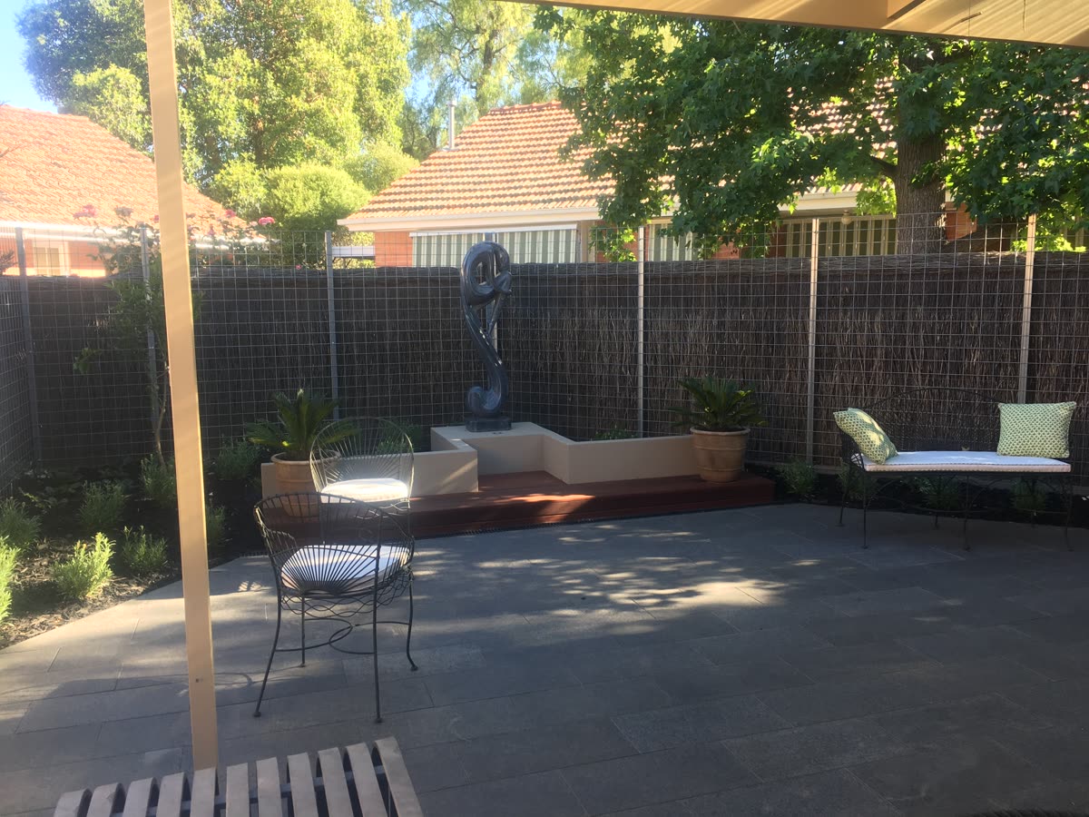 Dark abstract sculpture as a courtyard feature in Unley Park