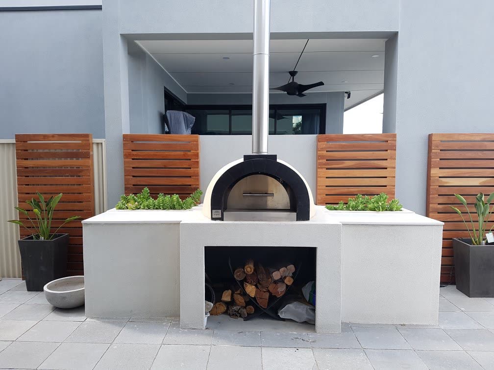 Custom rendered wood-fired pizza oven built into an outdoor kitchen bench with timber slat screening in West Lakes
